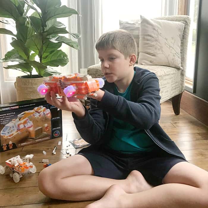 boy playing with Laser Pegs Stem Toys