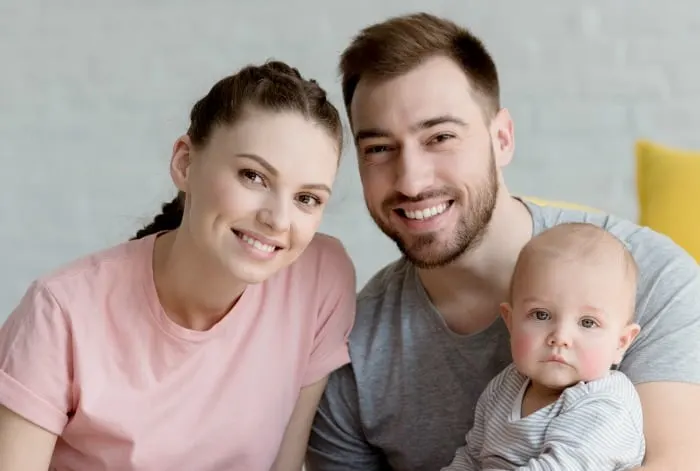 Young parents with child smiling